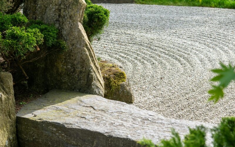 Serene Zen garden featuring a stone path and lush green foliage, ideal for meditation.